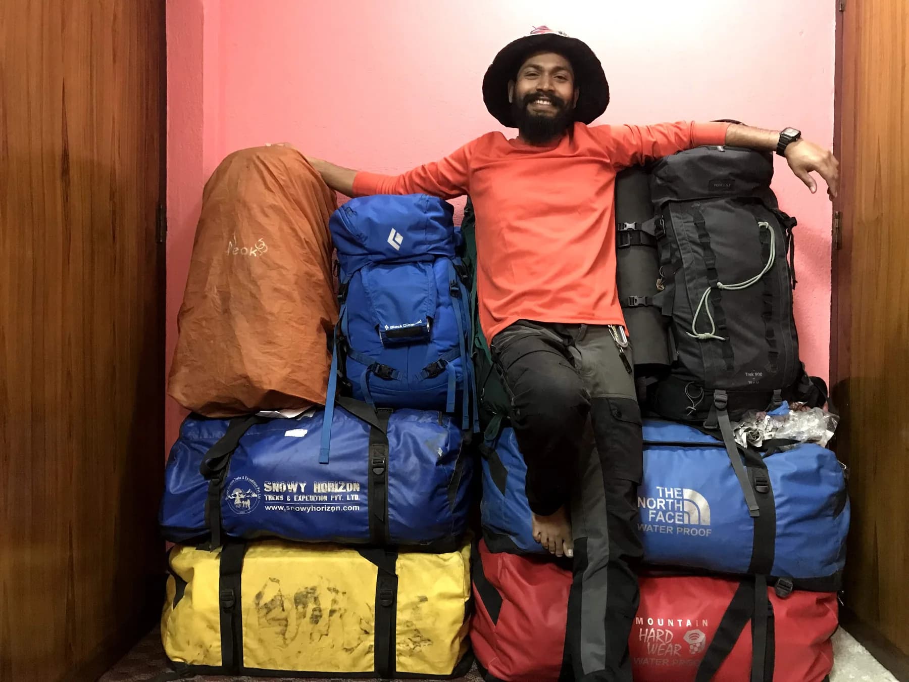 Intiaz Mahmud seated among backpacks and expedition duffel bags